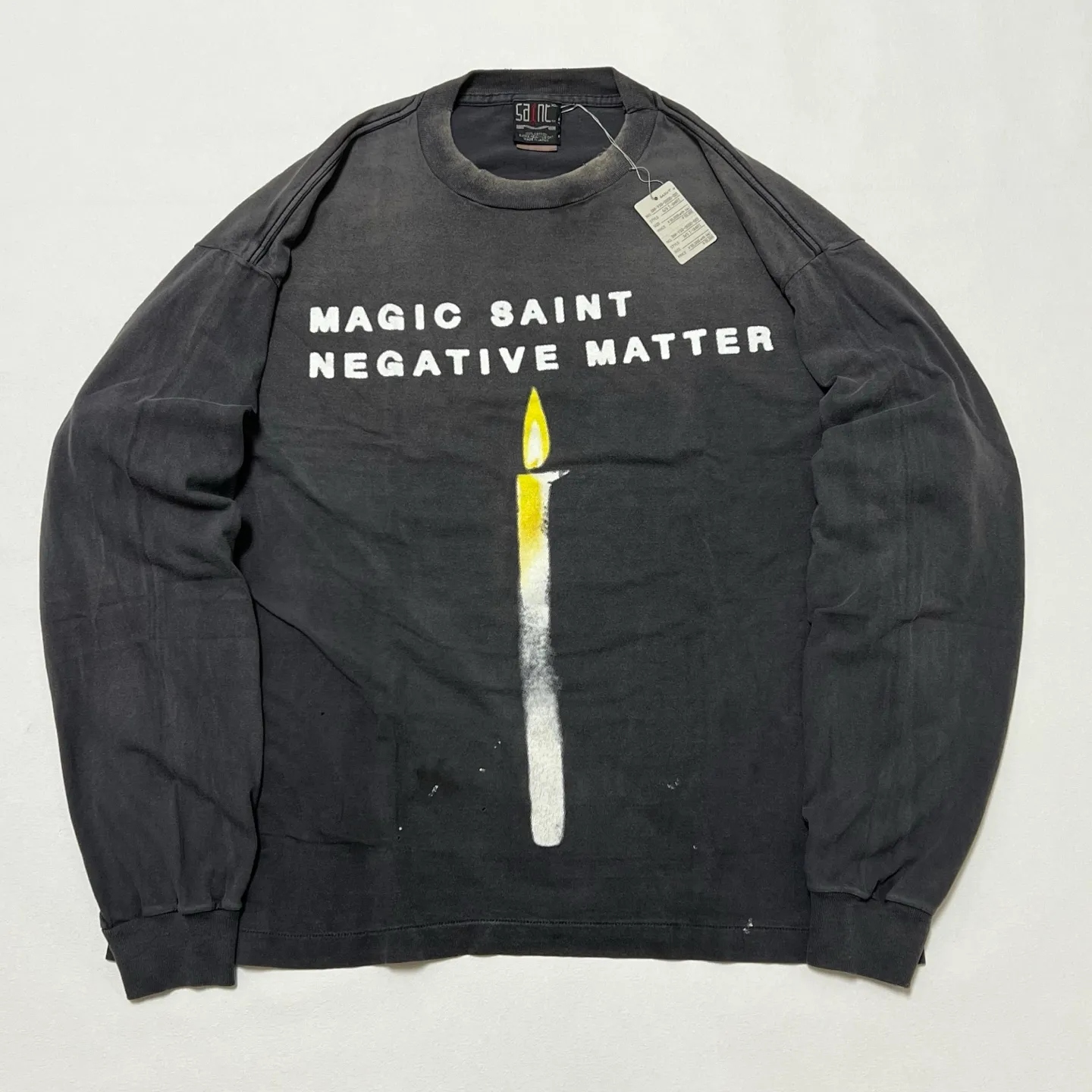 SAINT Mxxxxxx CANDLE LS TEE/BLK Slogan candle distressed long-sleeved TEE with angel short sleeves on the back. Washed black S-XL. Same as the original. Cylindrical side seam OE yarn fabric. Garment dyeing. Faded by heavy washing. Faded by plaster on bust. Correct alignment. Original consistent main mark/wash mark/cherub anti-counterfeiting mark. Original level printing restoration.